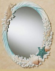Coral Medley Oval Wall Mirror - frame features rippled blue waves, textured coral highlighted with blue and tan, a tan seahorse, orange-washed scallop shells, a tan conch, charming pearl bubbles, and a turquoise blue starfish around a glass mirror.   seashell wall mirror seashell decor seashell bedroom decorating